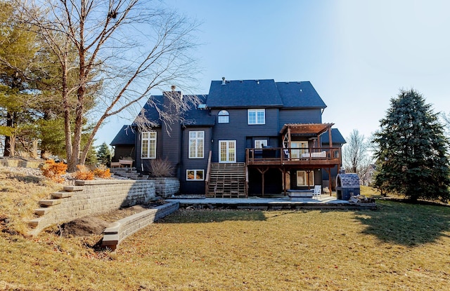 back of house featuring a lawn, stairway, a wooden deck, a chimney, and a patio area