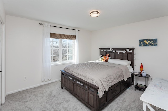 bedroom featuring baseboards and light colored carpet