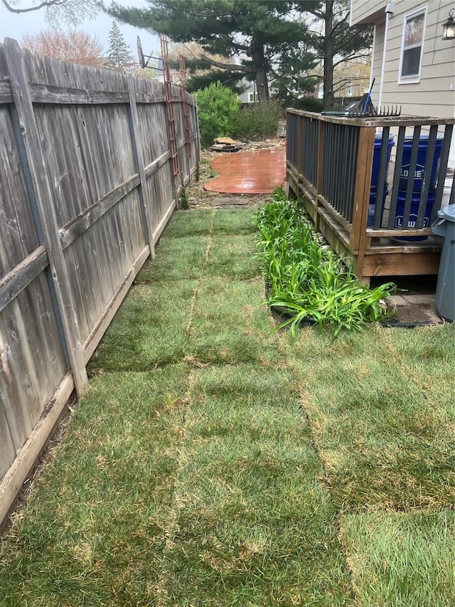 view of yard featuring fence and a wooden deck