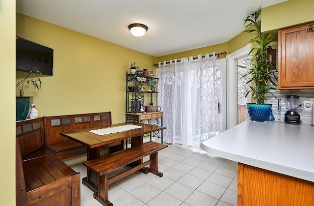 dining area with light tile patterned floors