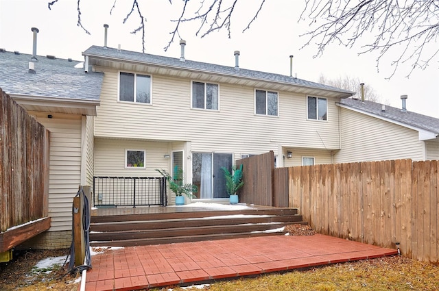 rear view of house with a patio area and fence