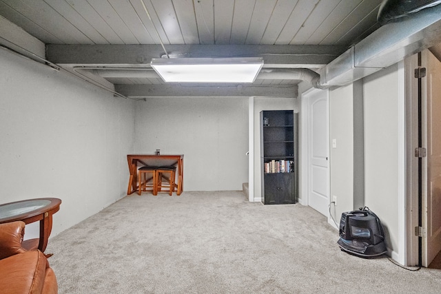 finished basement featuring wood ceiling and carpet flooring