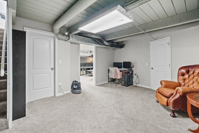 finished basement featuring stairway, baseboards, wood ceiling, and carpet flooring