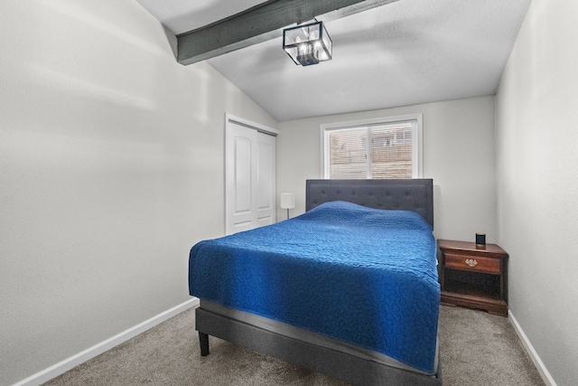 carpeted bedroom with lofted ceiling with beams, baseboards, and a closet