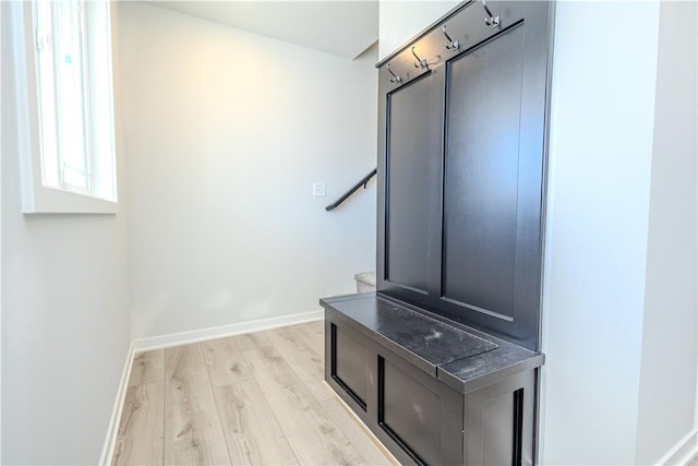 interior space featuring baseboards and wood finished floors