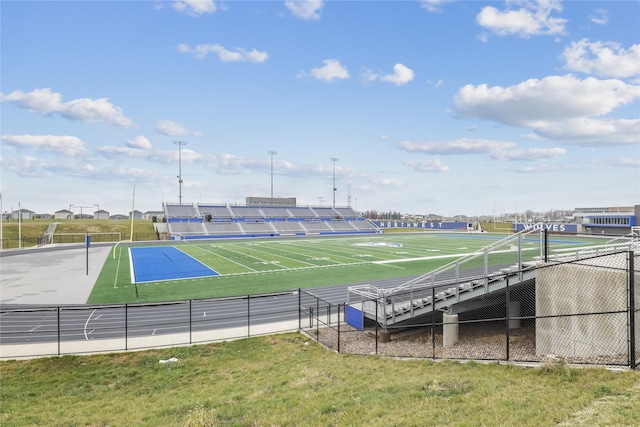 exterior space featuring a tennis court and fence