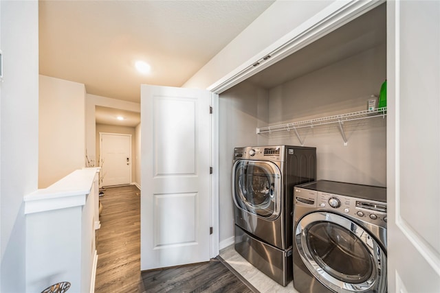 washroom with laundry area, dark wood-style floors, independent washer and dryer, and baseboards