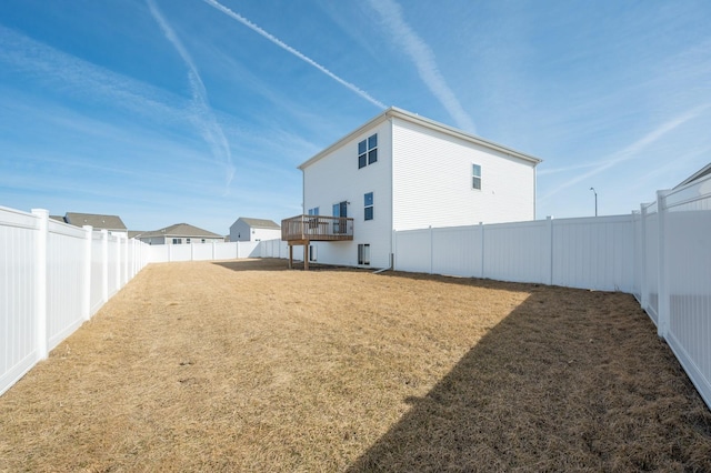 back of property featuring a yard and a fenced backyard