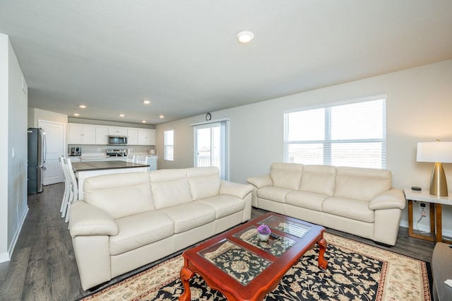 living room with recessed lighting, baseboards, and dark wood-style floors