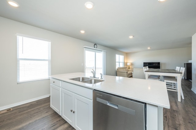 kitchen with a sink, dishwasher, white cabinets, and recessed lighting