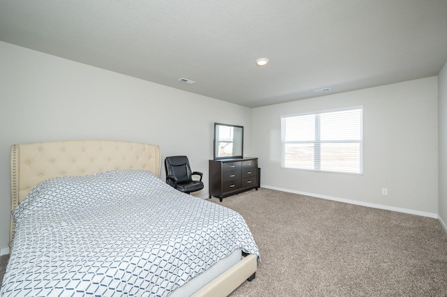 carpeted bedroom featuring baseboards and visible vents