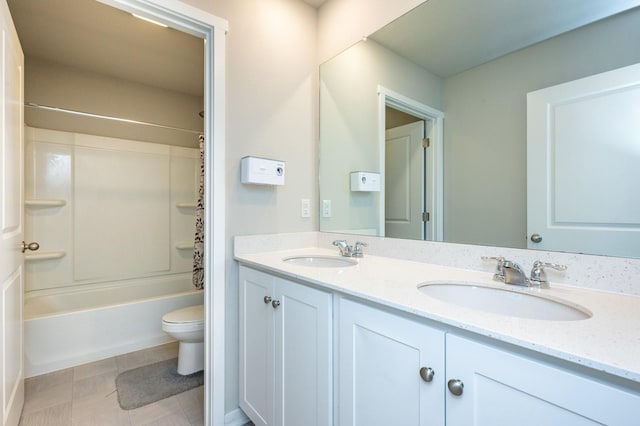 full bathroom with a sink, shower / tub combo, toilet, and double vanity