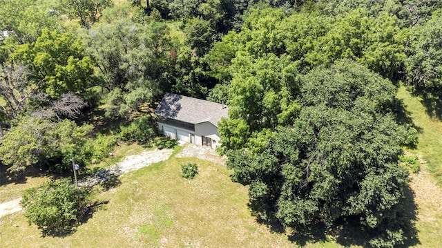 drone / aerial view featuring a wooded view