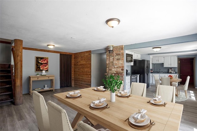 dining area featuring stairway and light wood-type flooring