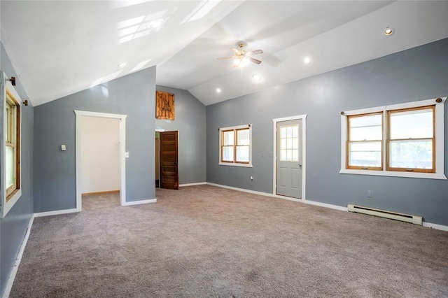 spare room with a baseboard heating unit, baseboards, carpet floors, vaulted ceiling, and a ceiling fan