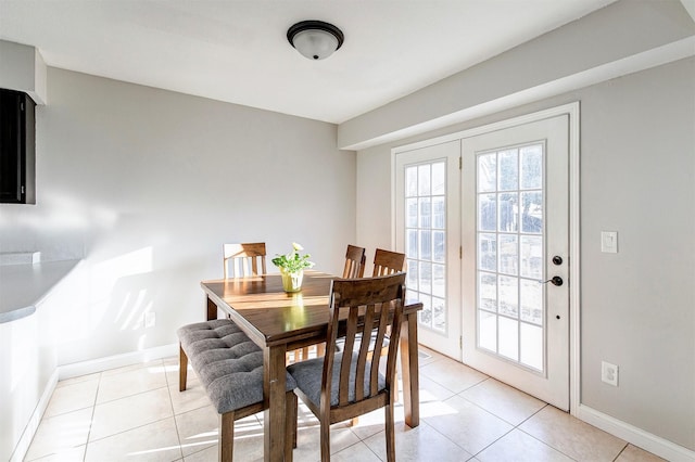 dining room featuring light tile patterned floors and baseboards