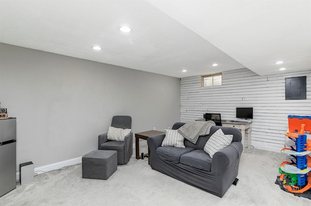 carpeted living area featuring wooden walls, recessed lighting, and baseboards