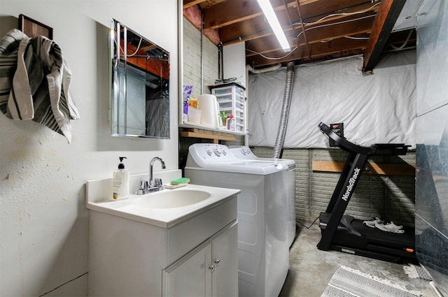 laundry room with washer and dryer, cabinet space, and a sink