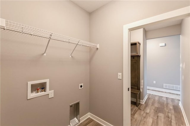 washroom with visible vents, light wood finished floors, laundry area, electric dryer hookup, and washer hookup