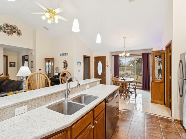 kitchen with visible vents, brown cabinets, appliances with stainless steel finishes, hanging light fixtures, and a sink