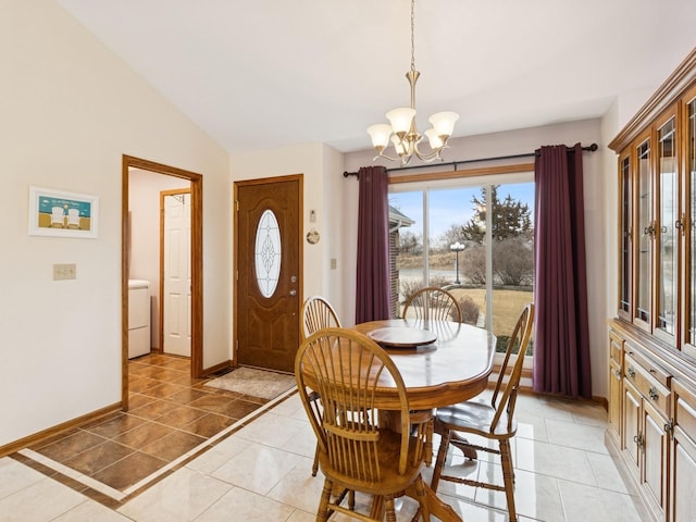 dining space with baseboards, a chandelier, lofted ceiling, light tile patterned floors, and washer / clothes dryer