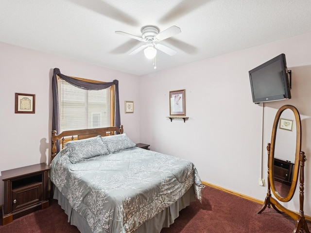 bedroom with dark carpet, a ceiling fan, and baseboards