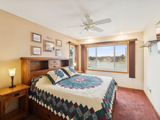 carpeted bedroom with ceiling fan and baseboards