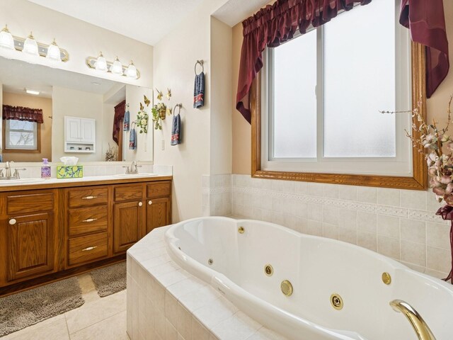 bathroom featuring a sink, a jetted tub, double vanity, and tile patterned flooring