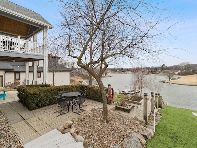 view of yard with a water view and a patio area