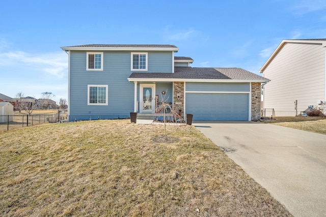 traditional-style home with a shingled roof, fence, a front yard, driveway, and an attached garage