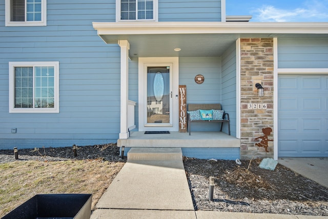 entrance to property with stone siding and a garage