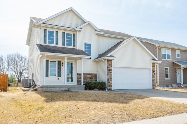 view of front of property with fence, central air condition unit, concrete driveway, a garage, and stone siding