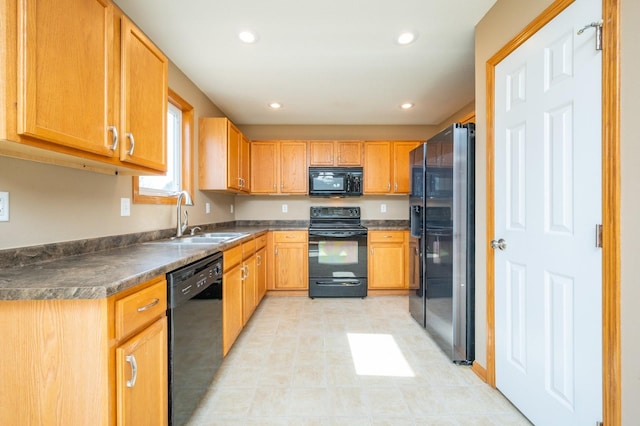 kitchen featuring a sink, dark countertops, black appliances, and recessed lighting