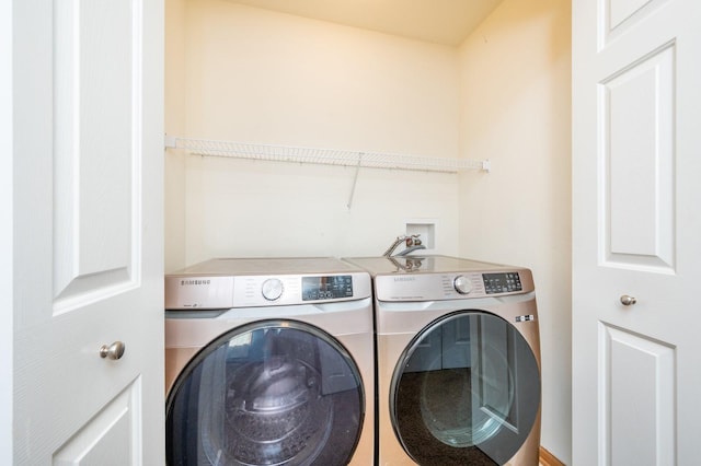 clothes washing area with laundry area and washer and clothes dryer