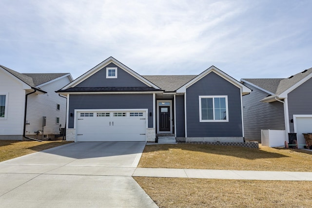 single story home with an attached garage, concrete driveway, and a front lawn