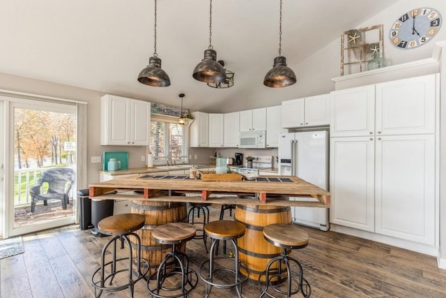 kitchen with wood finished floors, a center island, white cabinetry, white appliances, and light countertops