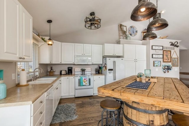 kitchen featuring white cabinetry, white appliances, vaulted ceiling, and a sink