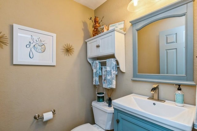 bathroom with toilet and vanity