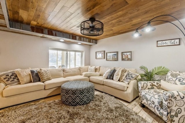 living area featuring wood ceiling and ceiling fan