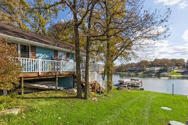 view of yard with a dock, stairway, and a water view