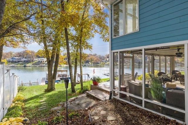 view of yard with fence and a water view