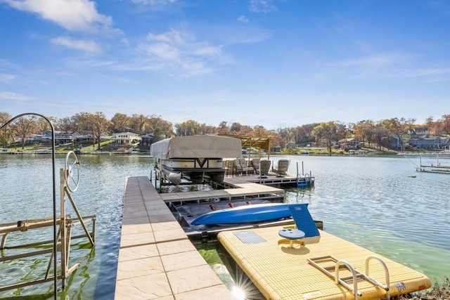 dock area featuring boat lift and a water view