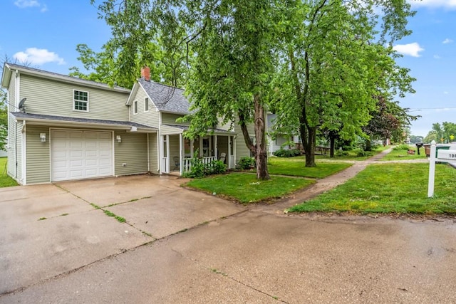 view of front facade with a front lawn, a porch, roof with shingles, a chimney, and driveway