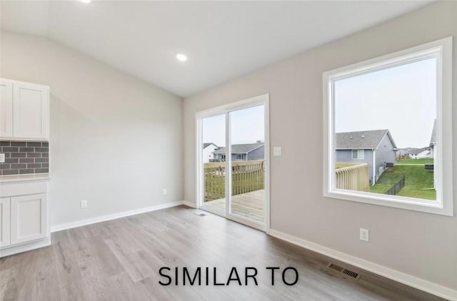 unfurnished dining area with recessed lighting, visible vents, baseboards, and light wood-style floors