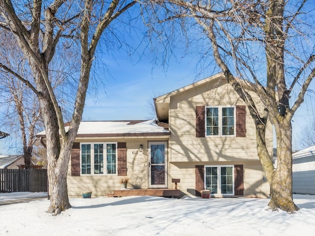 tri-level home featuring fence