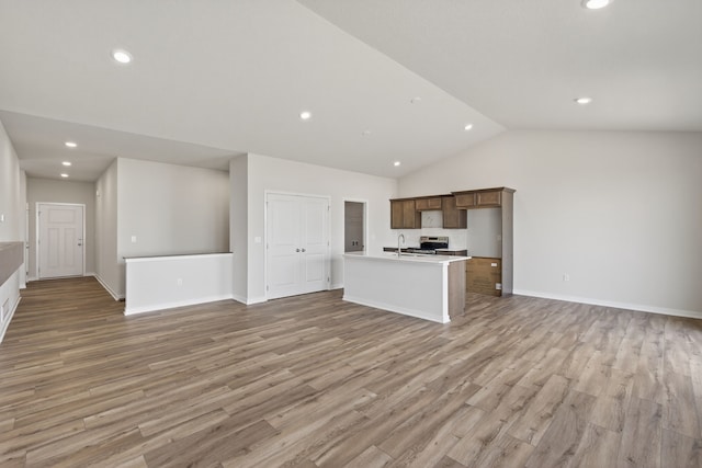 1811 Tuscany Dr SE, Altoona, IA 50009 - unfurnished living room featuring vaulted ceiling, recessed lighting, and light wood-type flooring