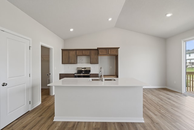 1811 Tuscany Dr SE, Altoona, IA 50009 - kitchen featuring stainless steel electric stove, decorative backsplash, light countertops, light wood-style flooring, and vaulted ceiling
