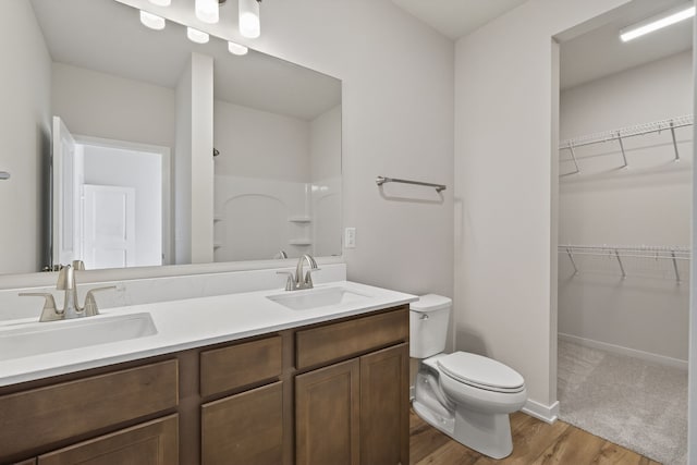 1811 Tuscany Dr SE, Altoona, IA 50009 - bathroom featuring double vanity, wood finished floors, a shower, and a walk in closet