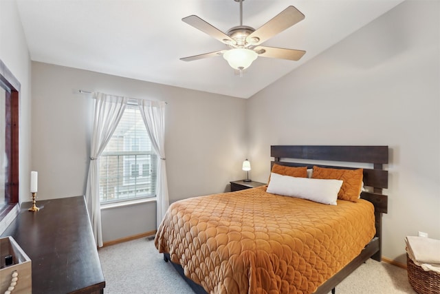 carpeted bedroom featuring baseboards, lofted ceiling, and ceiling fan