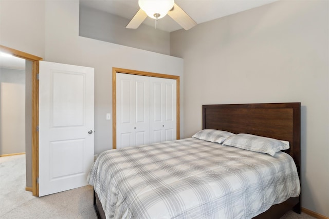 bedroom with a closet, a ceiling fan, and carpet floors